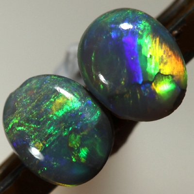 SOLID SEMI BLACK OPALS Matching pair. Bright multicolour